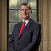 President Richard M. Englert Standing in front of a window.